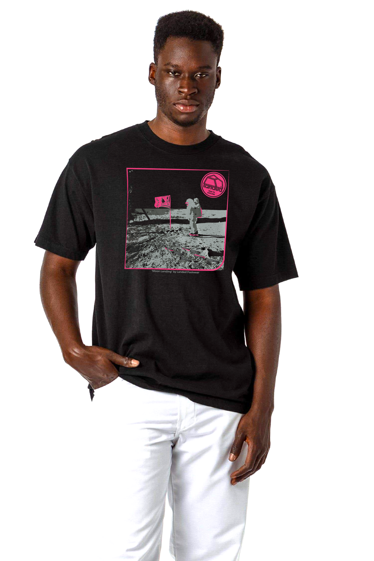 Landed black heavy-duty cotton t-shirt featuring a pink moon landing graphic print worn by a male model.