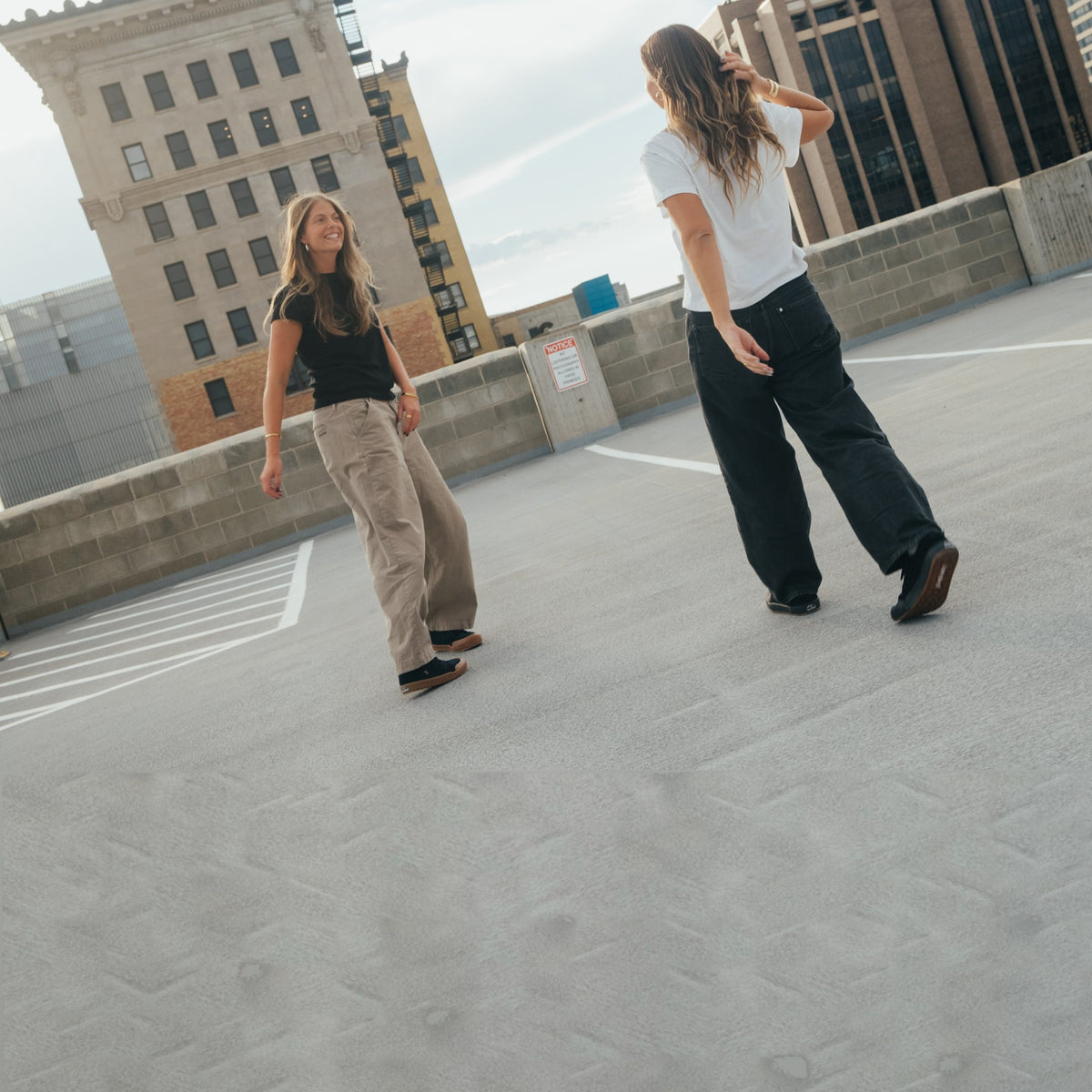 Two women walking on a rooftop in Landed shoes