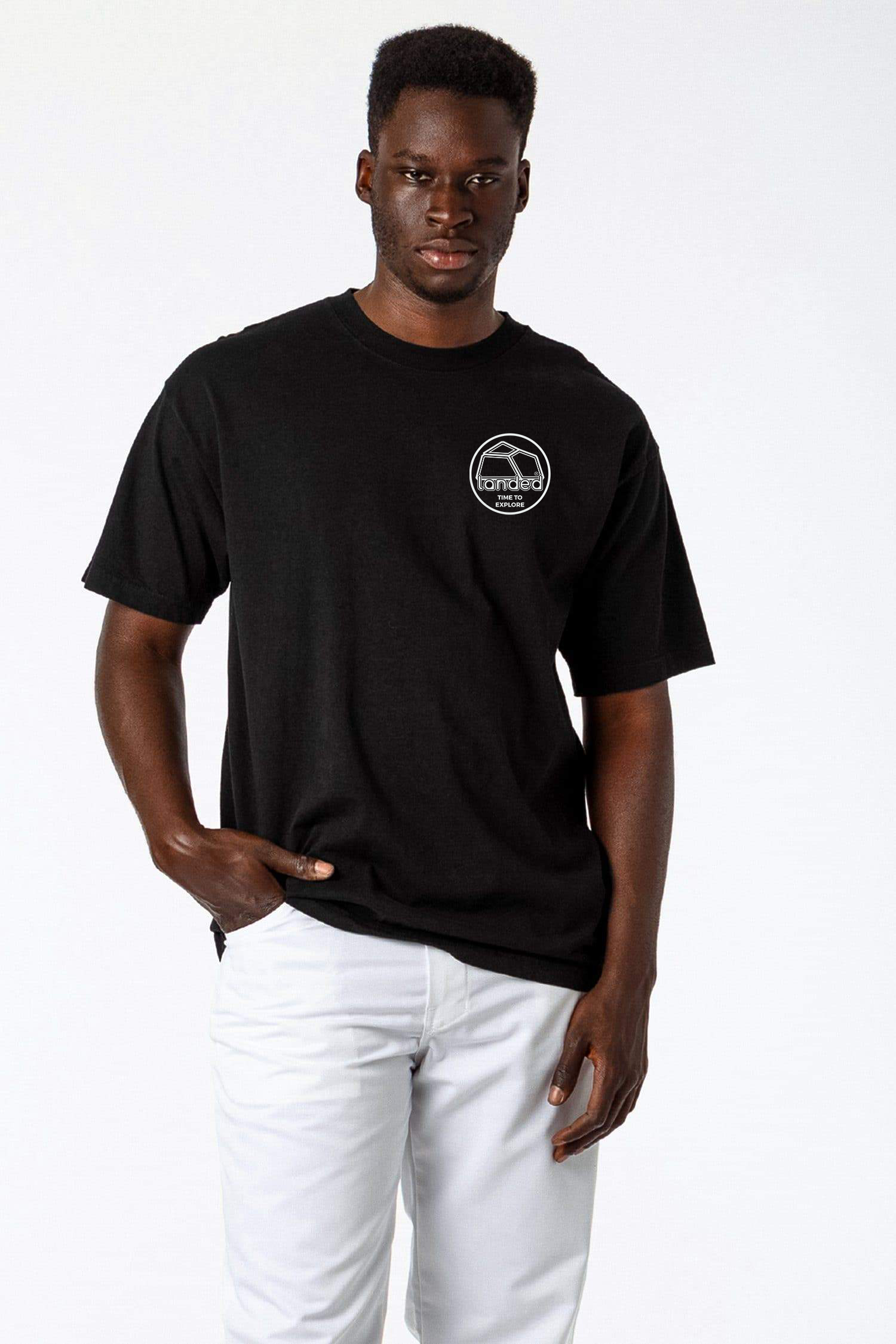 Landed Landmark heavyweight black cotton t-shirt with white embroidered logo on chest worn by a man