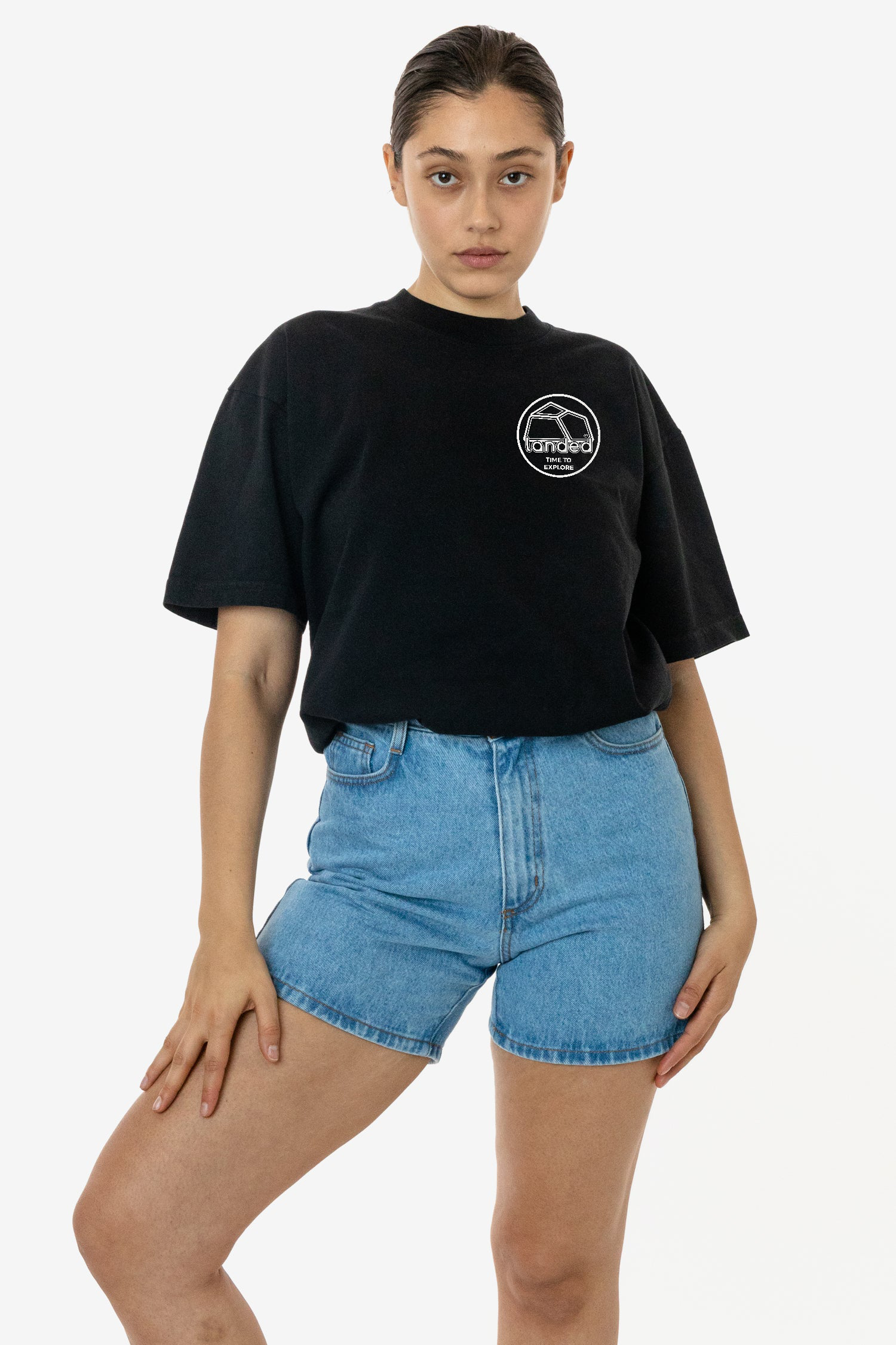 A model wearing a black Landed heavyweight cotton t-shirt with a white embroidered logo on the chest.