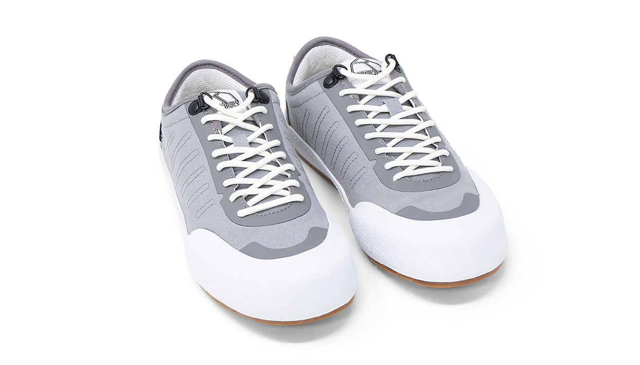 Landed The Overlook 1.0 grey and white technical sneakers with white laces and a gum rubber sole