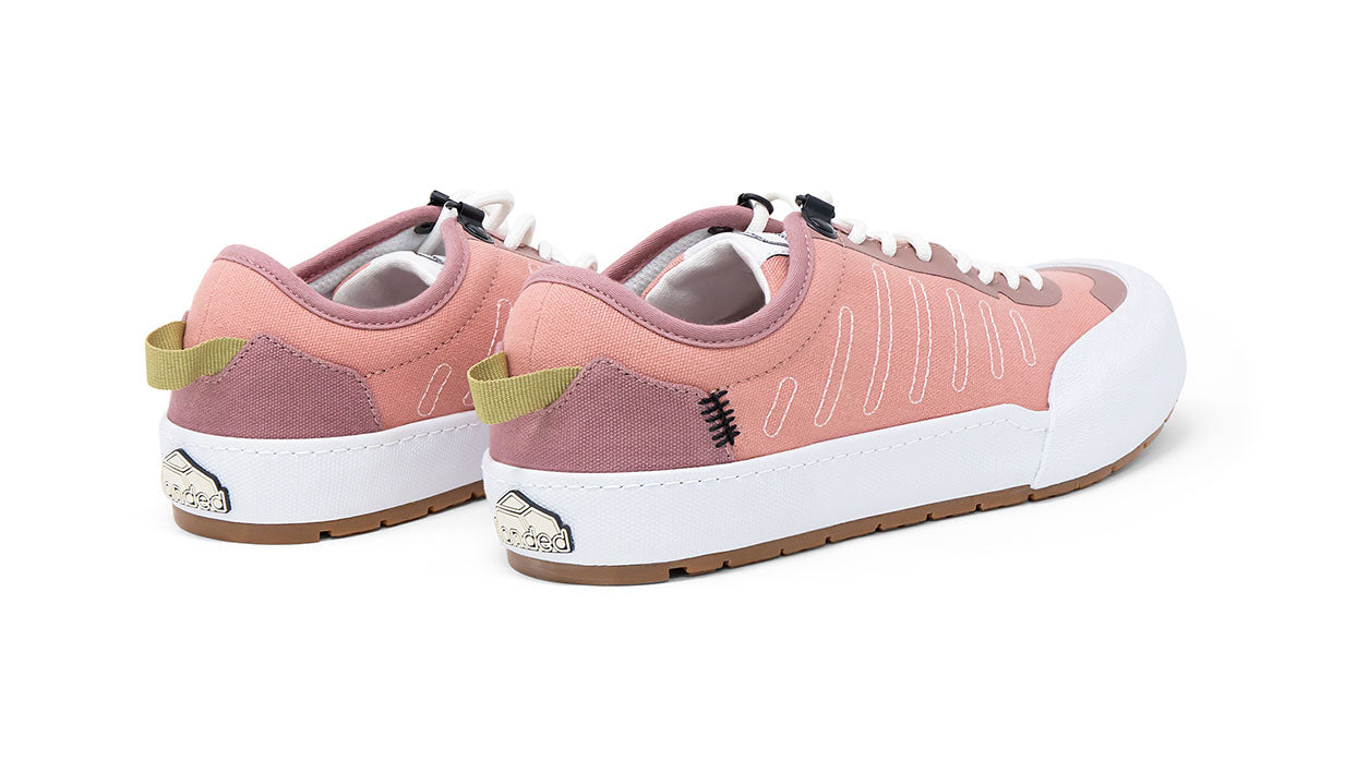 Landed The Overlook 1.0 technical sneakers in dusty rose and white with a durable rubber sole and heel pull tab.