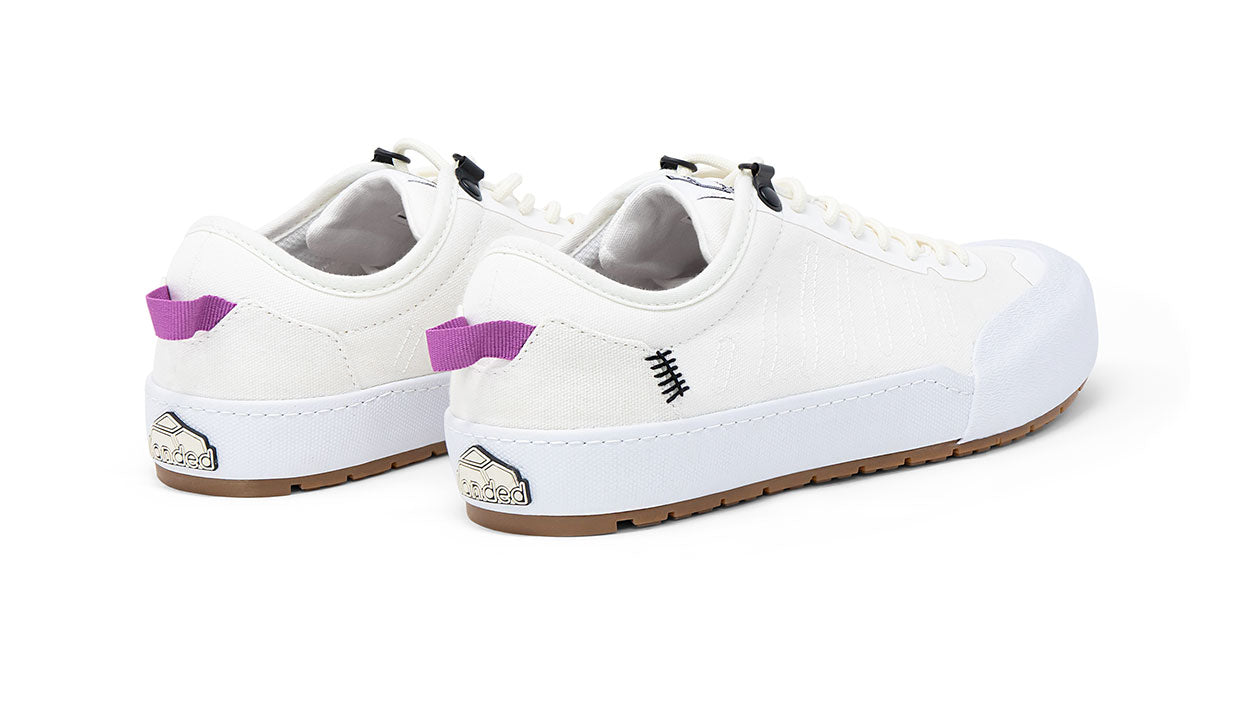 Landed The Overlook 1.0 white canvas technical sneakers with purple heel tabs and gum rubber soles