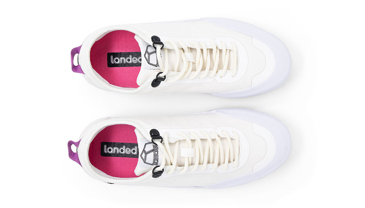 Top view of Landed The Overlook 1.0 white technical sneakers with pink insoles and purple heel pull tabs