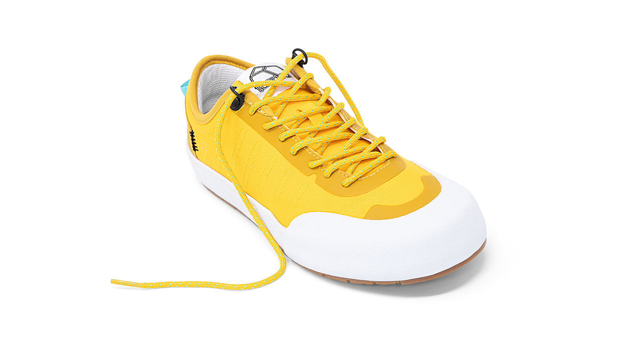 Landed The Overlook 1.0 yellow technical sneaker with white rubber toe cap and patterned laces