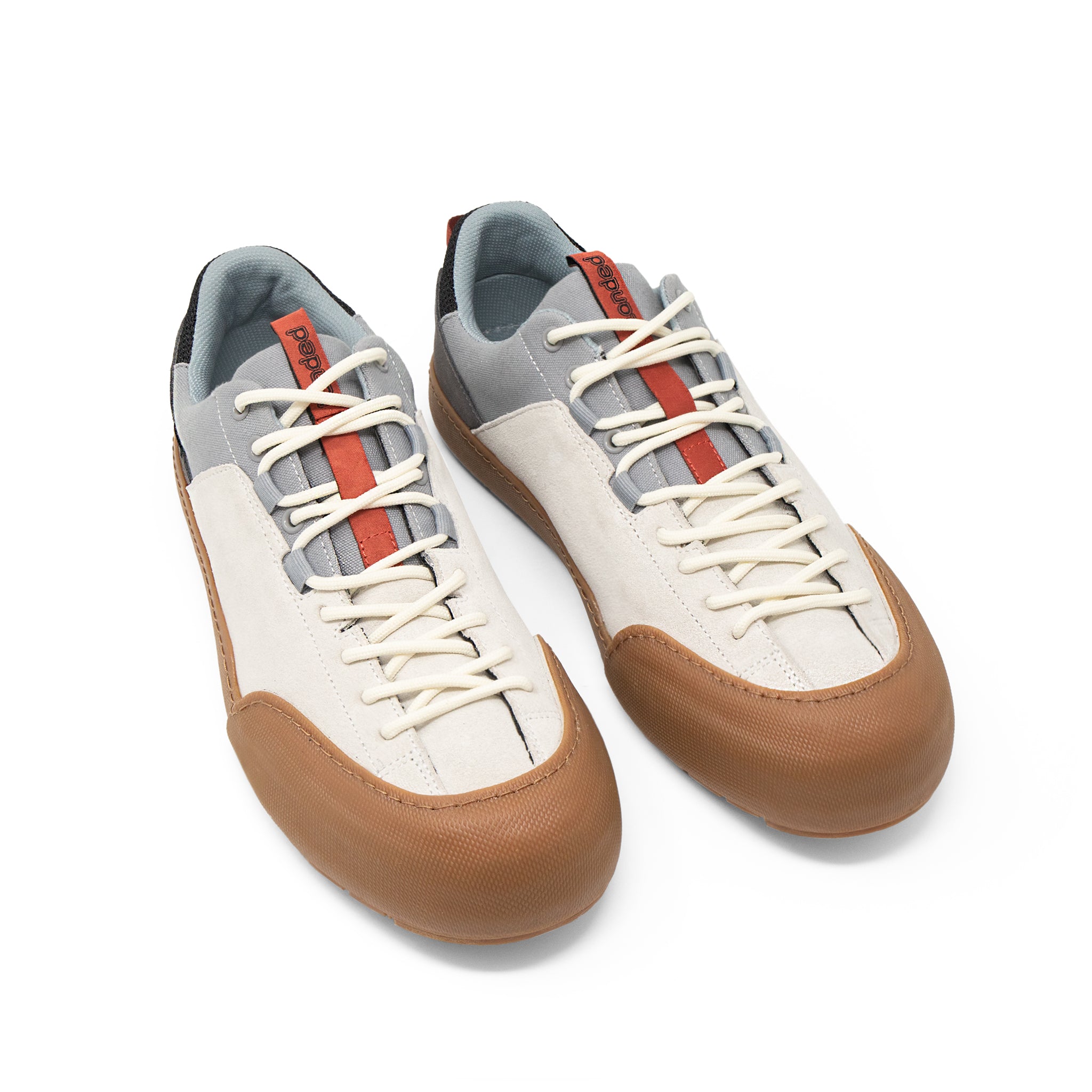 Landed The Switchback approach shoes in off-white, grey, and brown with a durable rubber toe cap and lacing system.