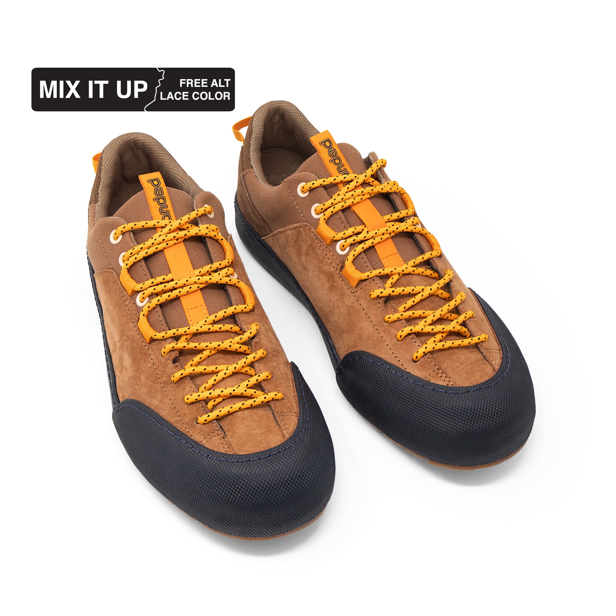 Landed The Switchback brown suede approach shoes with orange laces and black rubber toe caps on a white background.