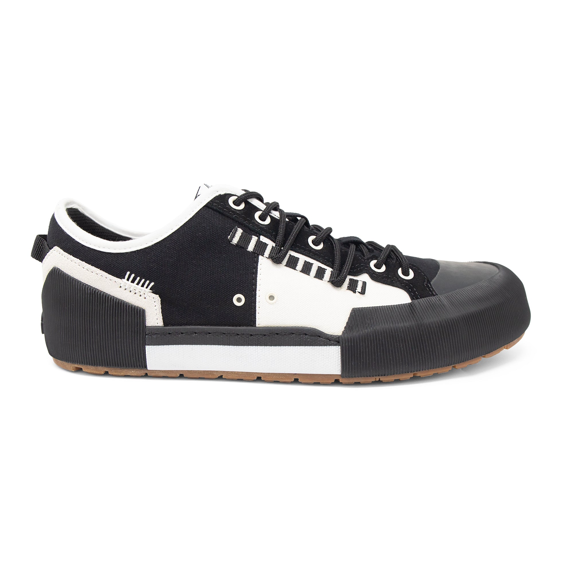 Landed The Banner sneaker in black and white canvas with a chunky rubber toe cap and textured midsole side view