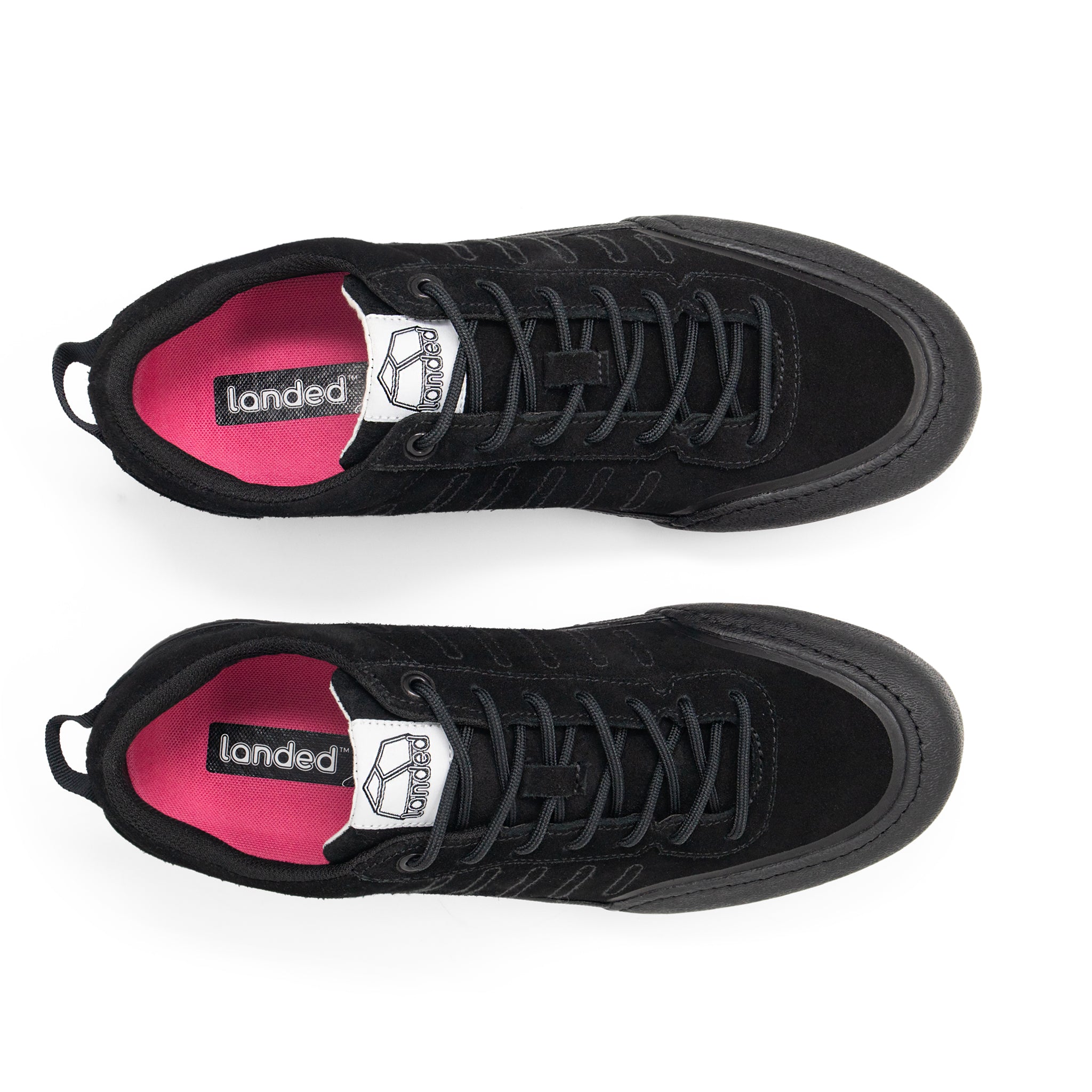 Landed The Overlook 2.0 black technical sneakers with bright pink insoles and black laces, top-down view.