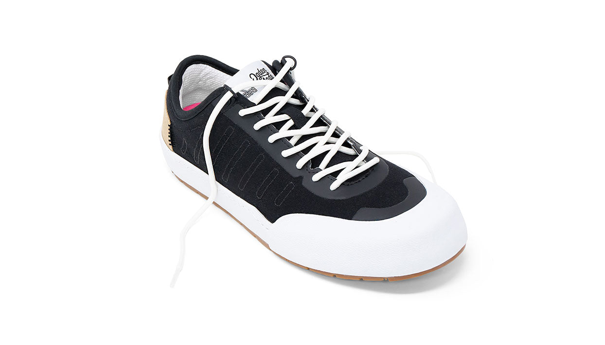 Landed The Overlook 1.0 black technical sneaker with white toe cap, white laces, and gum sole for everyday wear.
