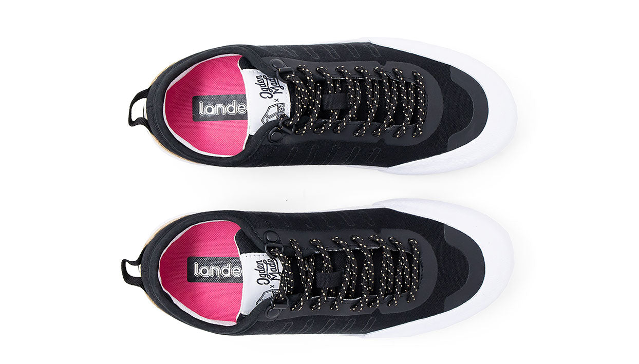 Landed The Overlook 1.0 black technical sneakers with white soles, pink insoles, and patterned laces, top view.