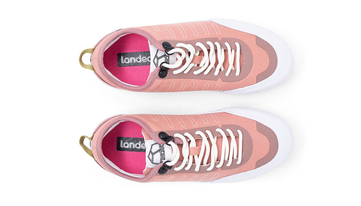 Landed The Overlook 1.0 technical sneakers in dusty rose with white soles and quick-lace system, top-down view.