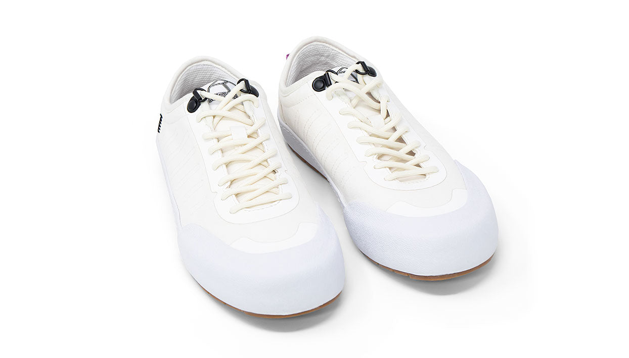Landed The Overlook 1.0 white technical sneakers with a durable rubber toe cap and lace-up closure.