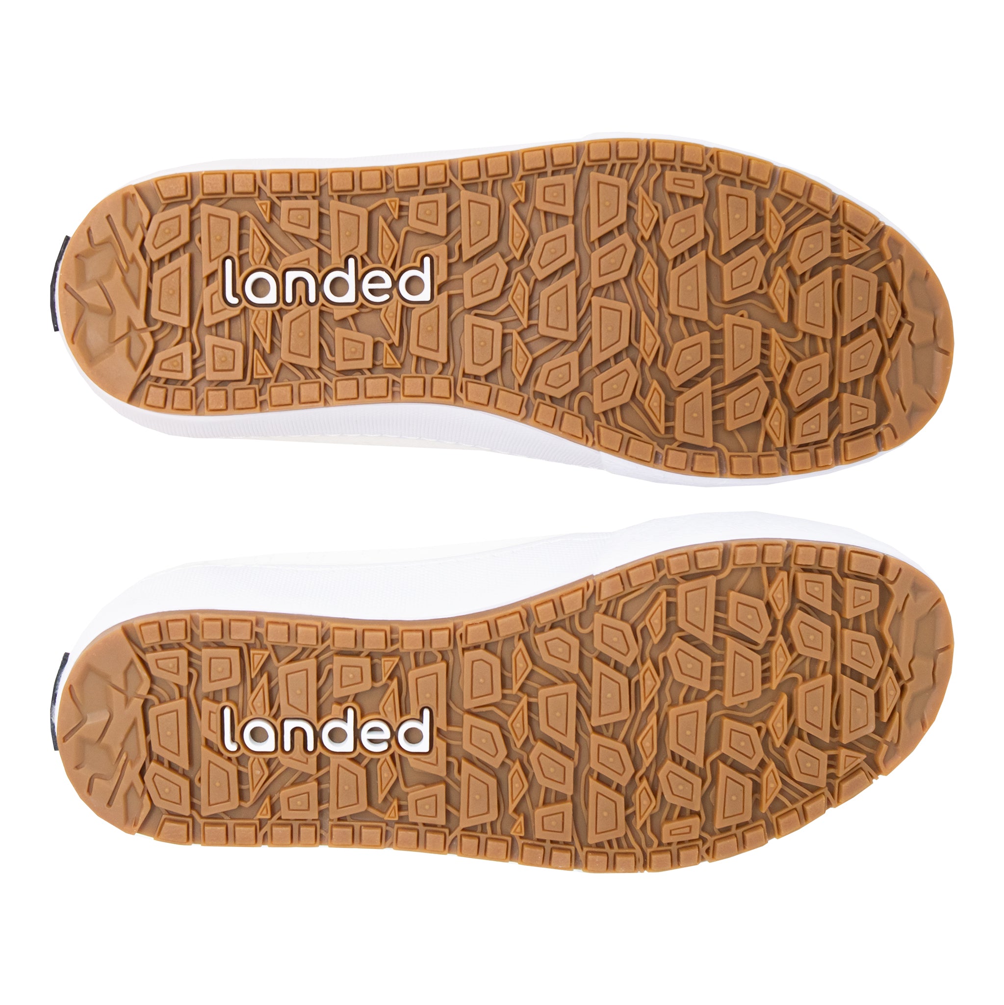 Bottom view of Landed The Switchback sneakers showing the brown rubber lugged outsoles with branded tread pattern