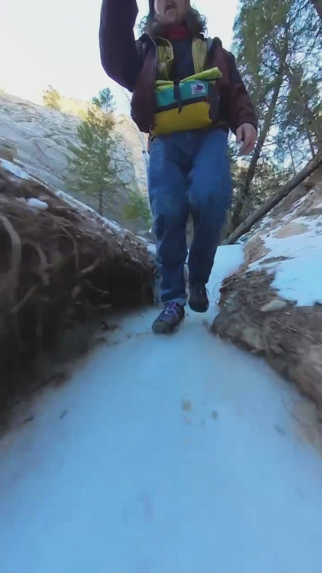 Hiker in Landed sneakers walking an icy canyon trail